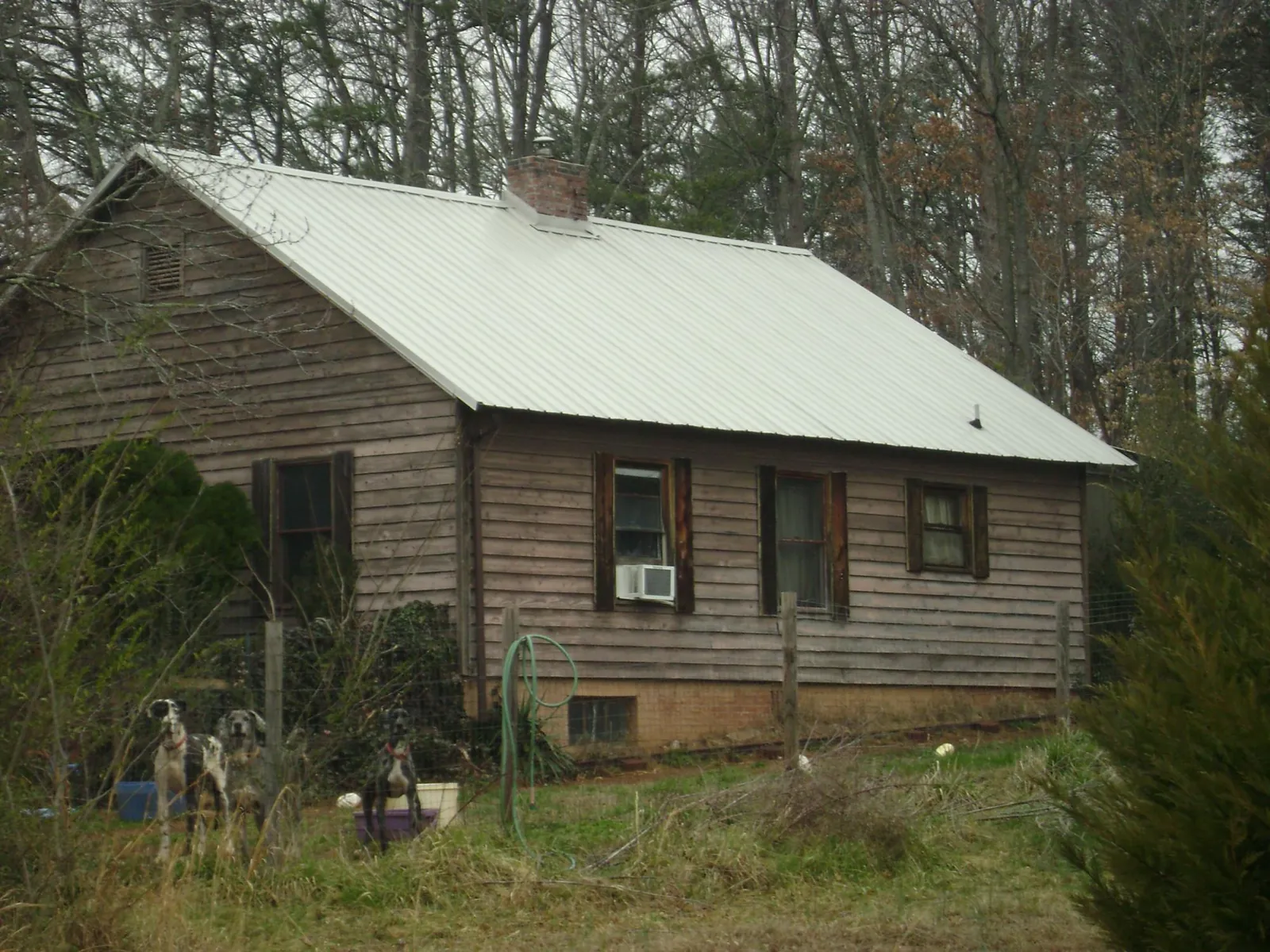 White metal roof on an old wood sided farmhouse, from a Metal Roof Installation job in Duncan